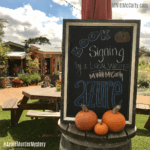 Pumpkins and my book signing signage at the Fall Festival | MWittMcCarty.com